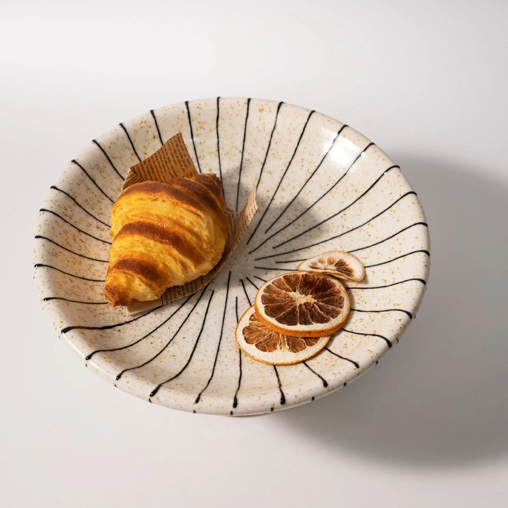 Black and white striped retro resin fruit plate on a table.