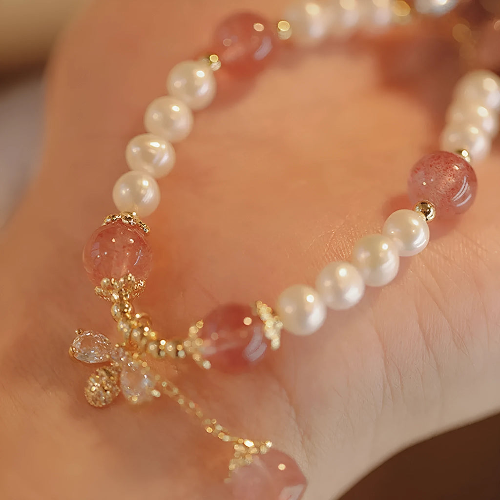 Women's strawberry quartz crystal bracelet with bow detail on wrist