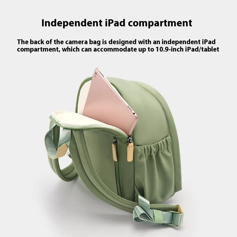Green polyester shoulder camera bag for women with a detachable iPad compartment on a curve belt.