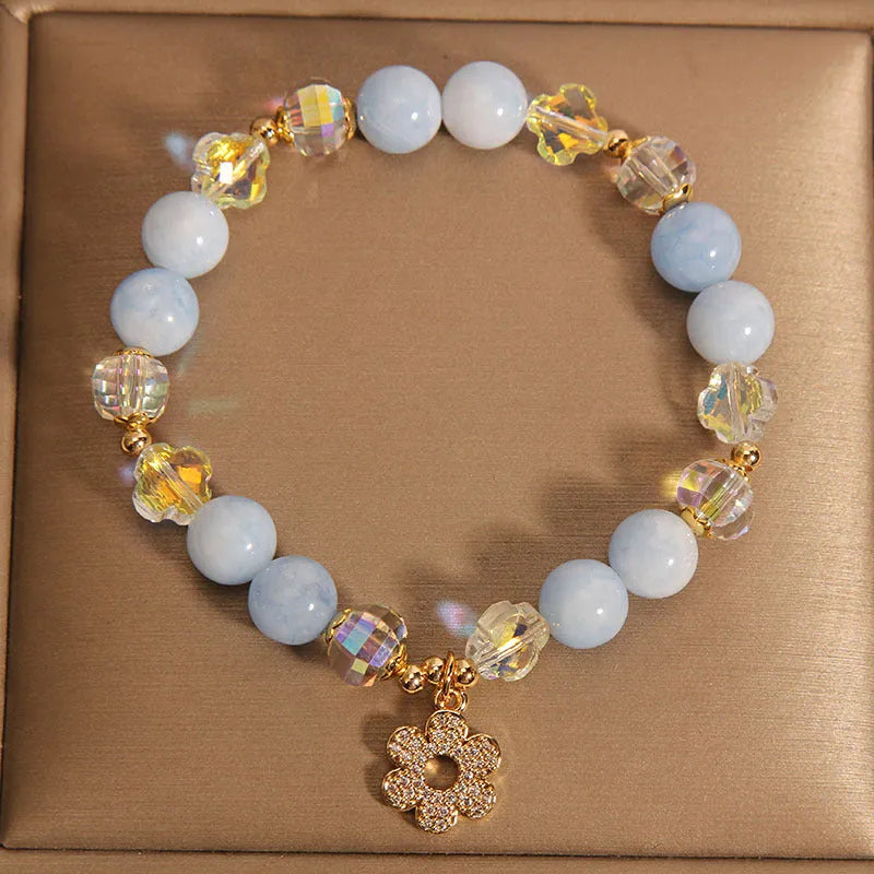 Women's aquamarine crystal four-leaf clover bracelet with pearl detail on adjustable silver chain