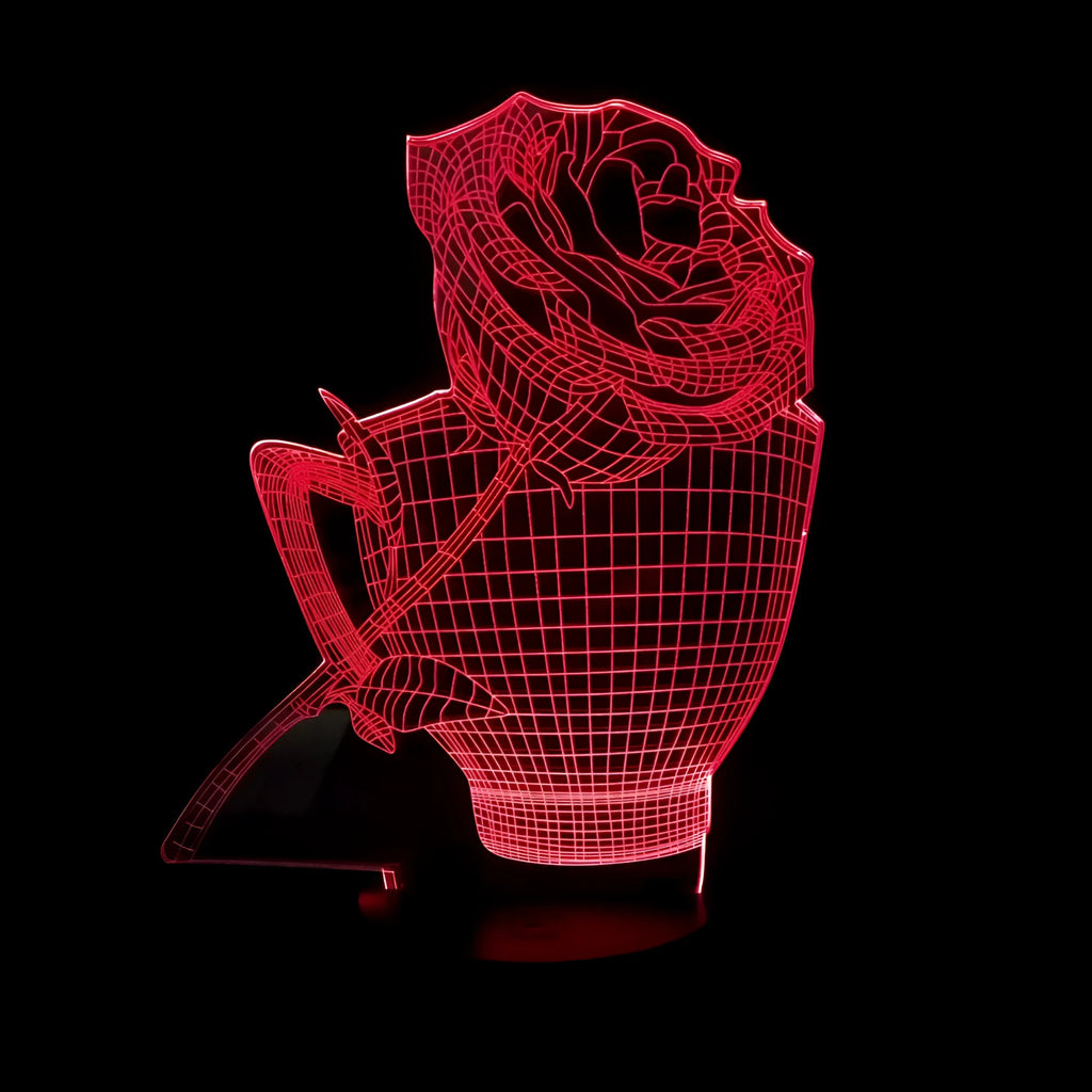 3D acrylic rose flower night light with remote control on a table, displaying purple light.