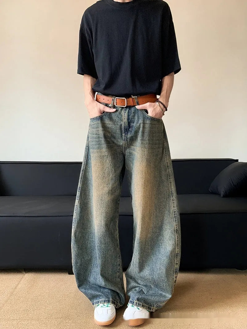 Men's retro blue distressed denim wide-leg trousers showing slim fit and vintage detailing