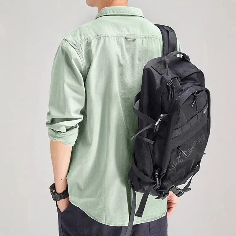 Man wearing a loose-fit light grey polyester cardigan shirt with long sleeves and an overalls design detail.