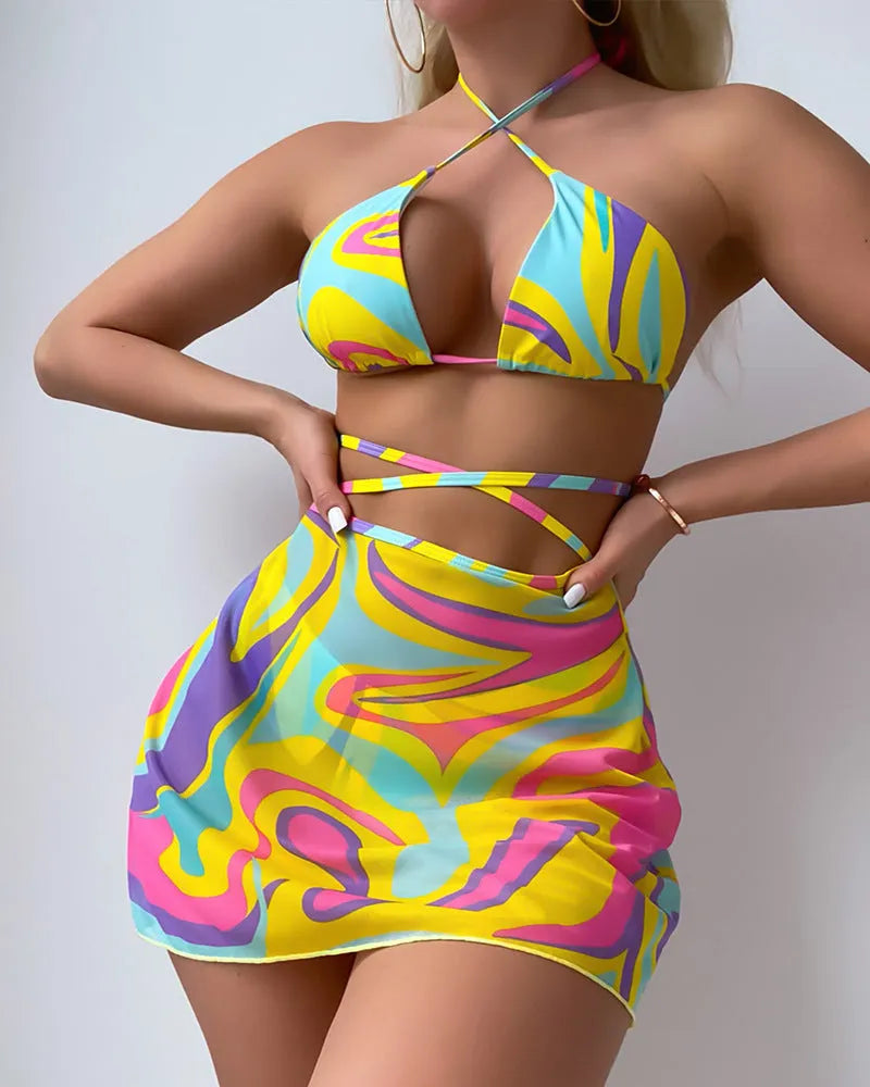 Yellow striped halter neck swimsuit with lace-up front, matching skirt, and shorts set for women.
