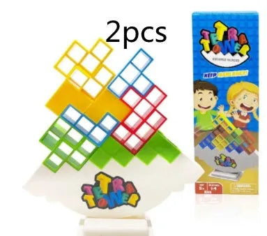 Plastic balance stacking game with 16 coloured blocks, chassis, and base on a table.