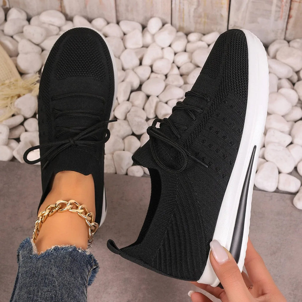 Women's low-top red casual sneakers with round toe and lace-up front on a white background.