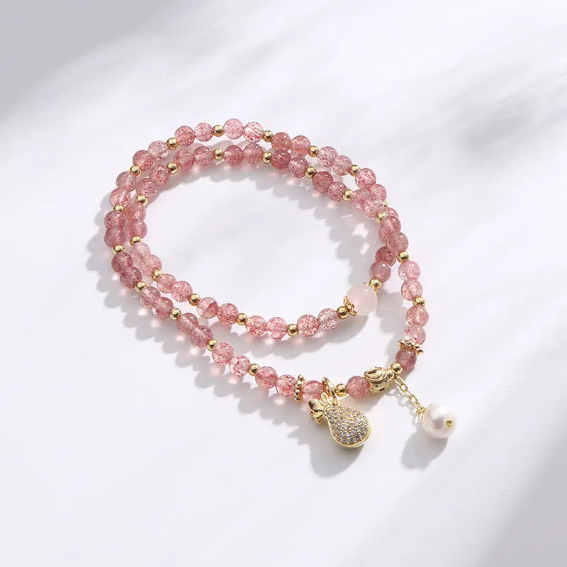 Strawberry quartz crystal bracelet with geometric pink beads on adjustable string