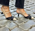 Women's apricot and black colour block stiletto heel sandals with pointed toe and buckle fastening.