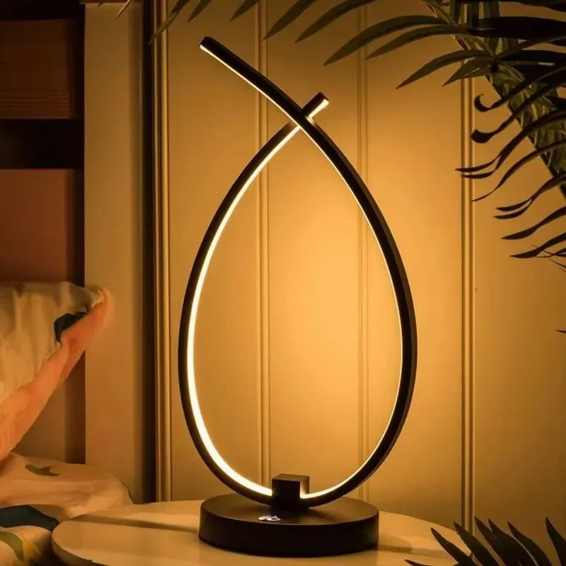 Black and white drop-shaped USB bedside table lamp with touch or switch control.