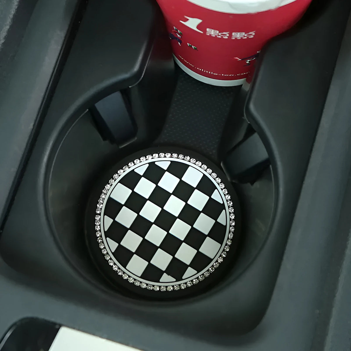 Plastic universal car cup holder mat in a black and white checkerboard pattern
