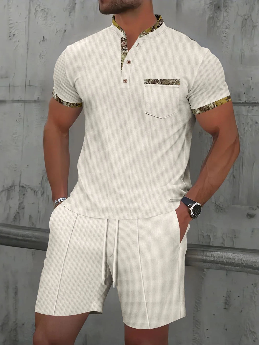 Man modelling a grey waffle knit zip-up polo short sleeve top and matching shorts.