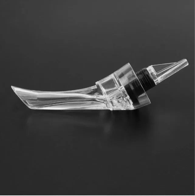 Clear acrylic wine aerator with stainless steel filter measuring 16x4.2cm pouring red wine into a glass