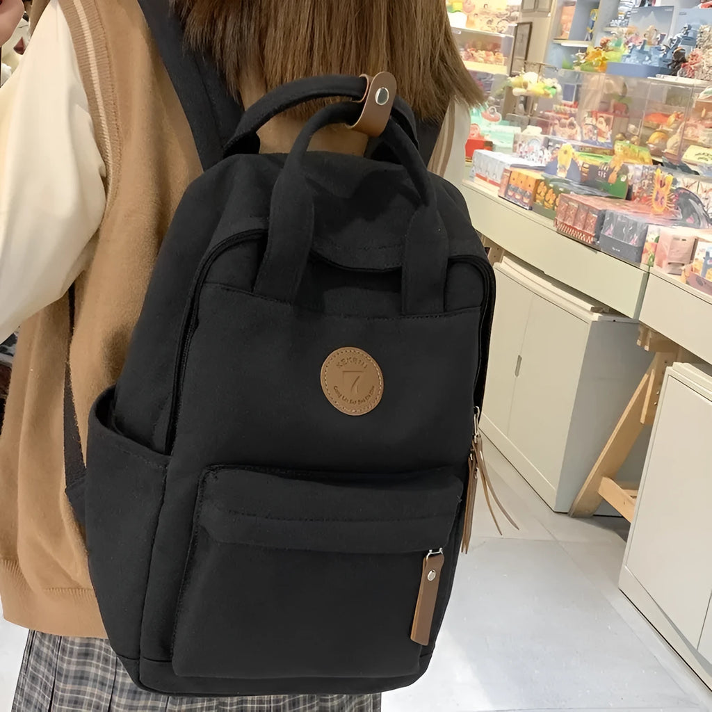 Black Oxford cloth unisex backpack with curved shoulder straps in an urban simplicity style.