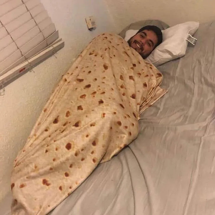 Round coral fleece burrito blanket with food print, shown wrapped.