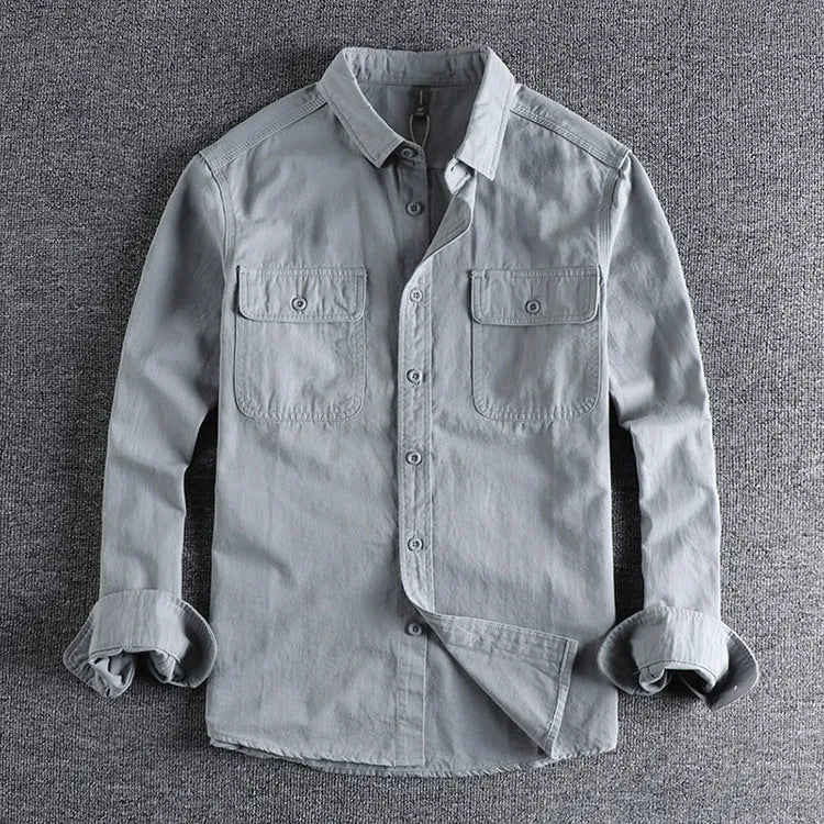 Man wearing a loose-fit light grey polyester cardigan shirt with long sleeves and an overalls design detail.
