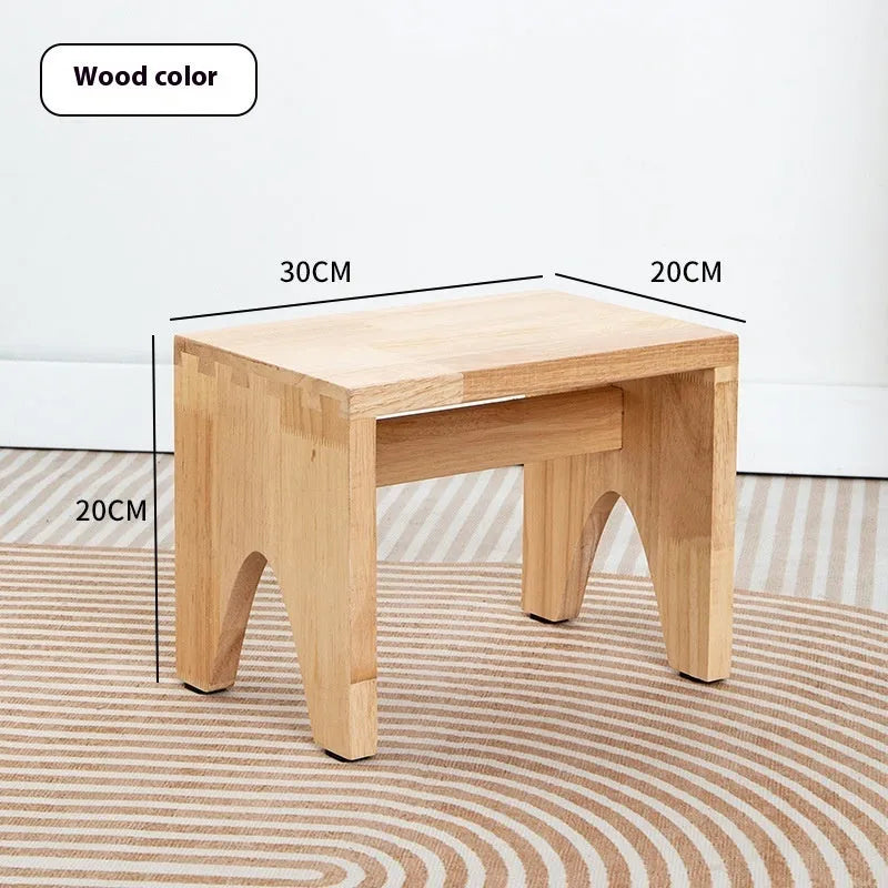 Distressed finish wooden shoes changing stool with bracket construction legs.