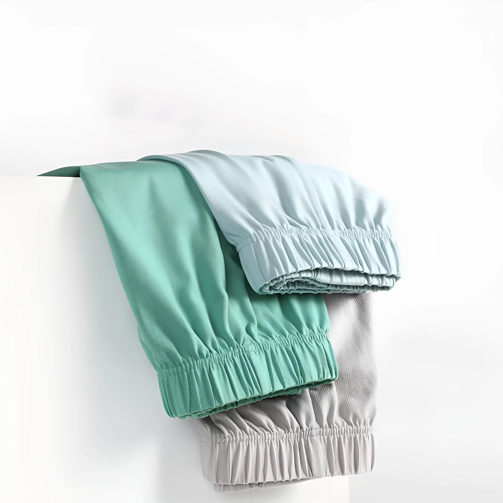 Men's loose-fitting cotton boxers in solid colours: gold, green, sea blue, and light grey.