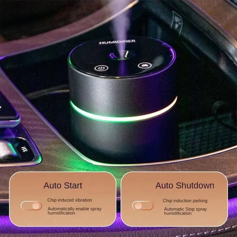 Black portable aluminium car air humidifier and essential oil diffuser with night light on a desk.