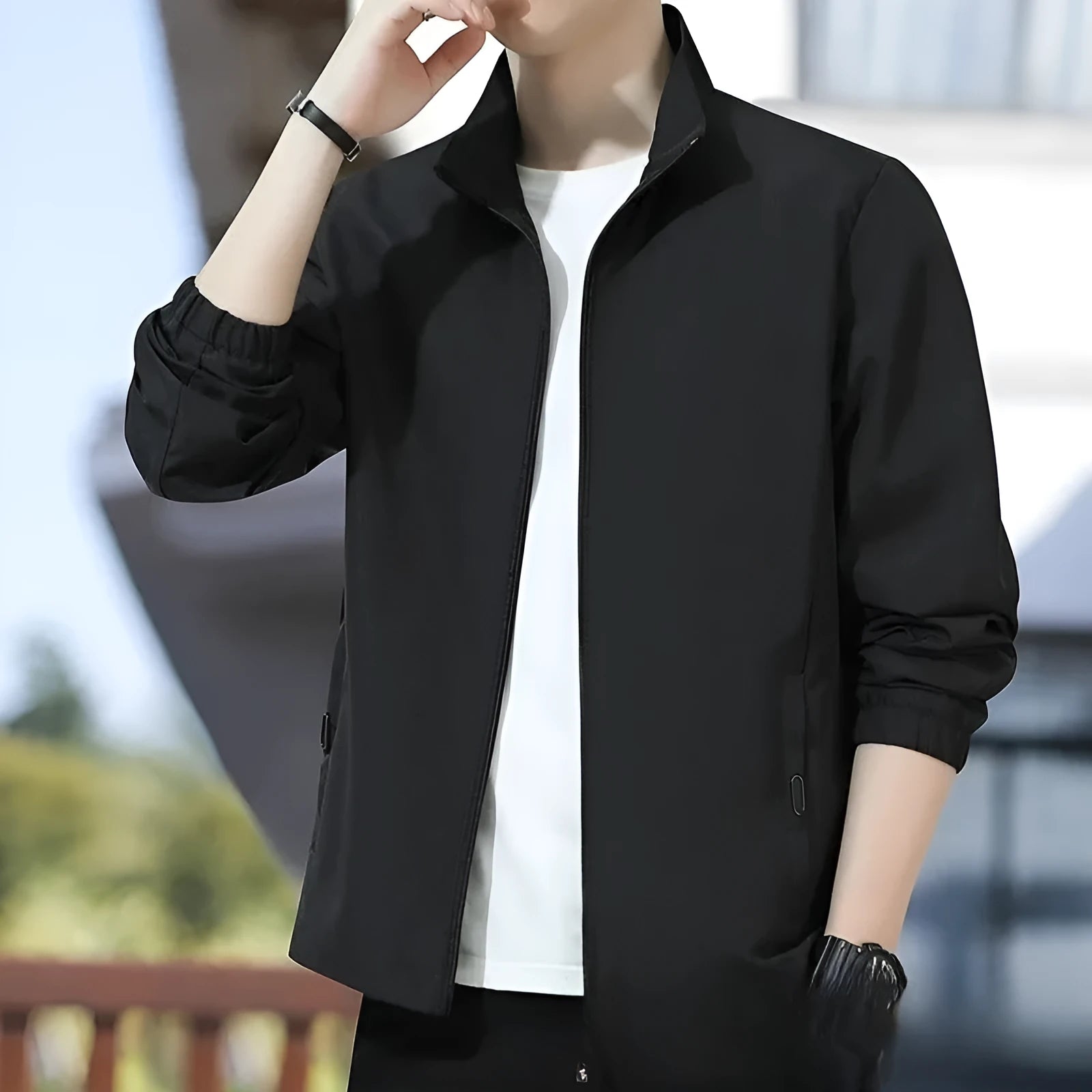 Man wearing a black Korean-style loose lapel casual jacket with zipper pockets.
