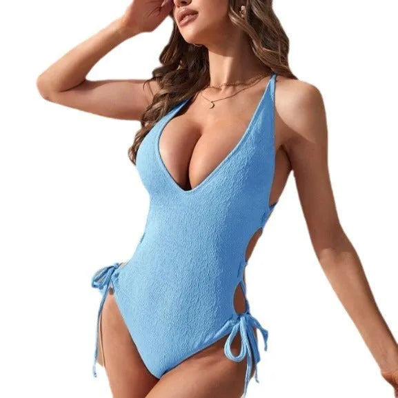Women's black hollow backless tether one-piece swimsuit made from polyester fabric.