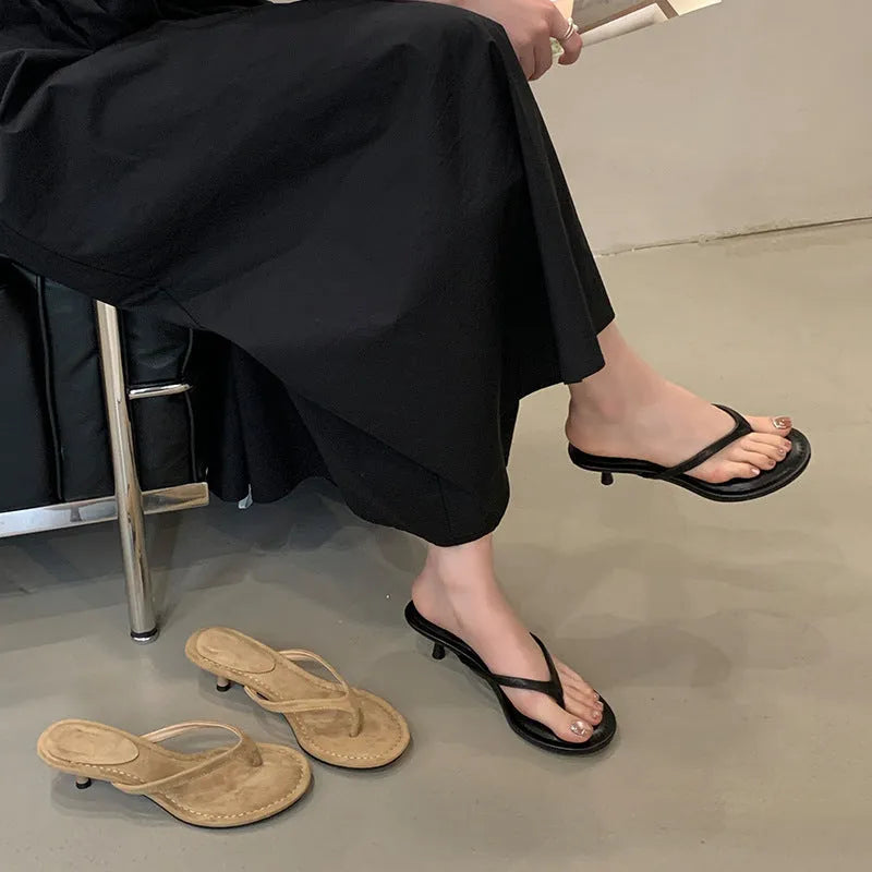 Women's black rubber stiletto sandals with round toe and open-toed design on a white background.
