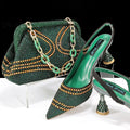Women's pointed toe high heel shoe and matching small bag set with rhinestone detail on a wine glass heel.