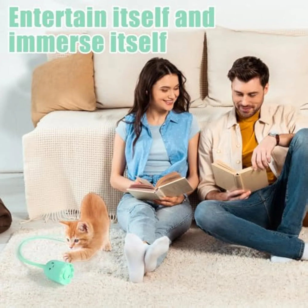 Green automatic electronic cat wand toy with swinging silicone tails on a table