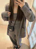 Women's loose-fit knit cardigan, vest, and trousers three-piece set in wool blend fabric.