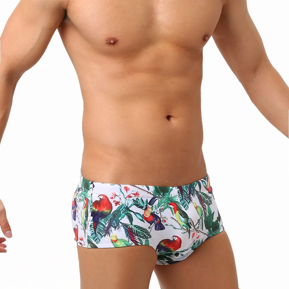 Men's swimming trunks with a colourful floral and bird print, shown in briefs and boxers styles.