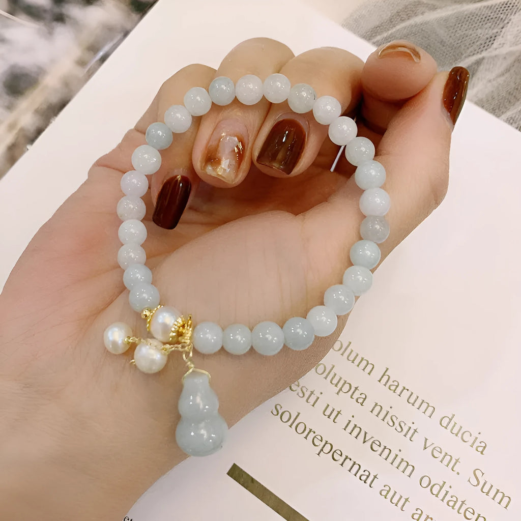 Emerald jade bracelet with hand-carved gourd design in traditional Chinese style