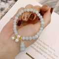 Emerald jade bracelet with hand-carved gourd design in traditional Chinese style
