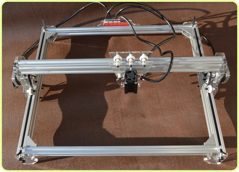 Miniature desktop laser engraving machine with a 400mm by 300mm base plate.