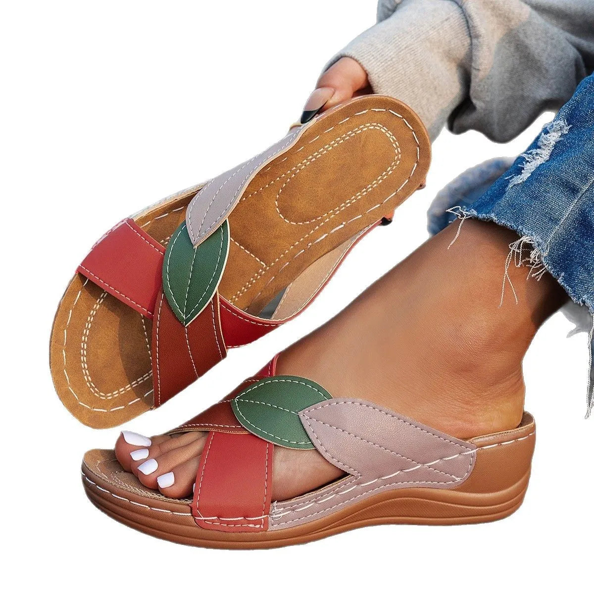 Women's black slippers with thick soles and cross-straps, showing peep-toe design.