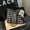 Black wool shoulder bag with horizontal square shape and internal organisation compartments