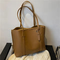 Large capacity soft leather tote bag in beige with synthetic leather lining and double shoulder straps.