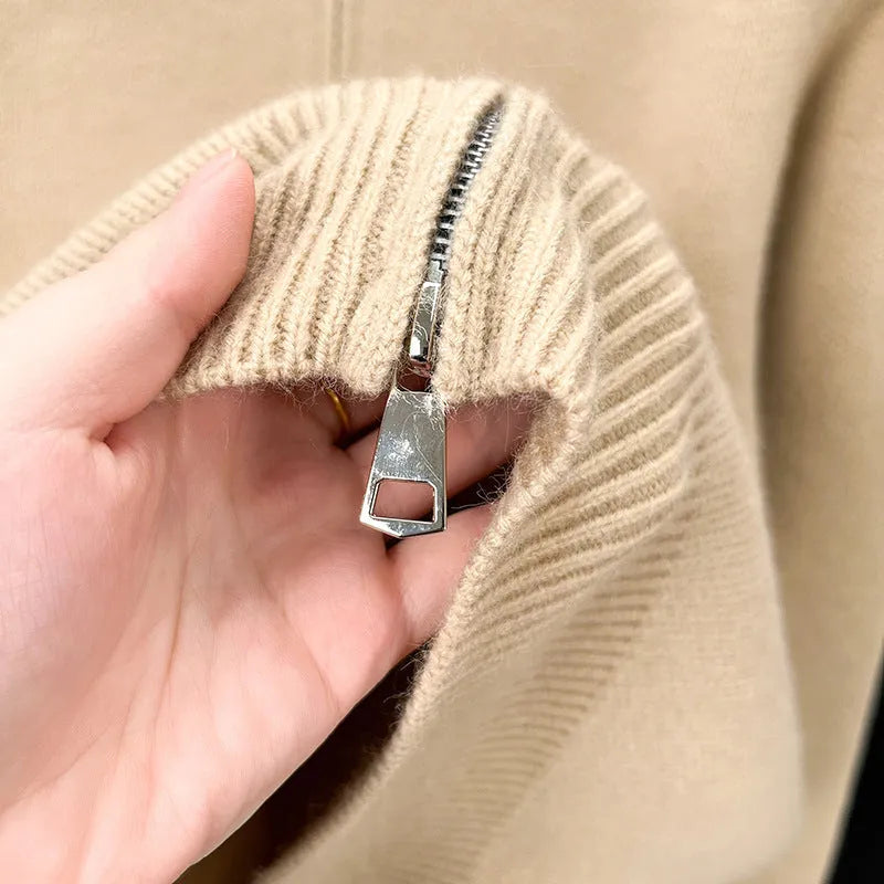 Man wearing a loose-fit, grey, stand collar knitted cardigan with a full-length front zipper.