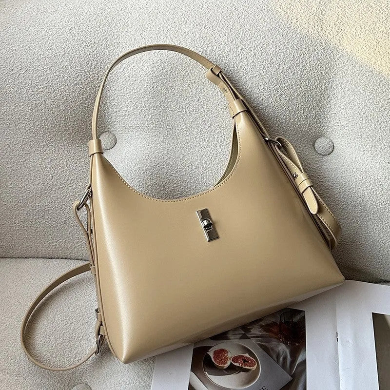 Soft genuine leather crossbody shoulder bag in dumpling shape with internal phone pocket and change compartment