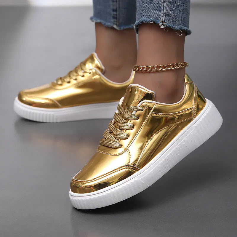 Gold sequinned platform sneaker with round toe and thick MD sole on a white background