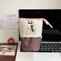 Brown collapsible pencil case with cartoon print, showing 17cm by 14cm size.