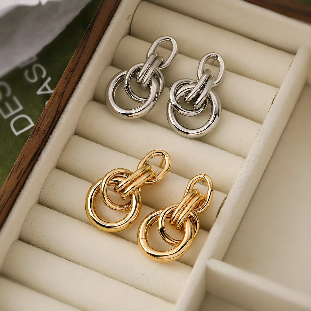 Geometric gold earrings with irregular design elements on copper base with gold electroplating