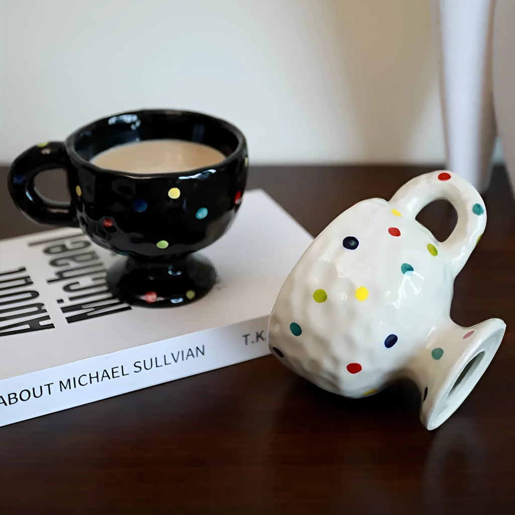 Hand-pinched irregular shaped solid colour ceramic mug on a table, showing its unique form and modern simplicity design.