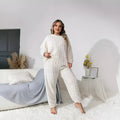 Women's creamy white polyester plush two-piece lounge suit with crewneck top and matching trousers