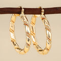 Geometric copper earrings with ring and line design elements in golden finish