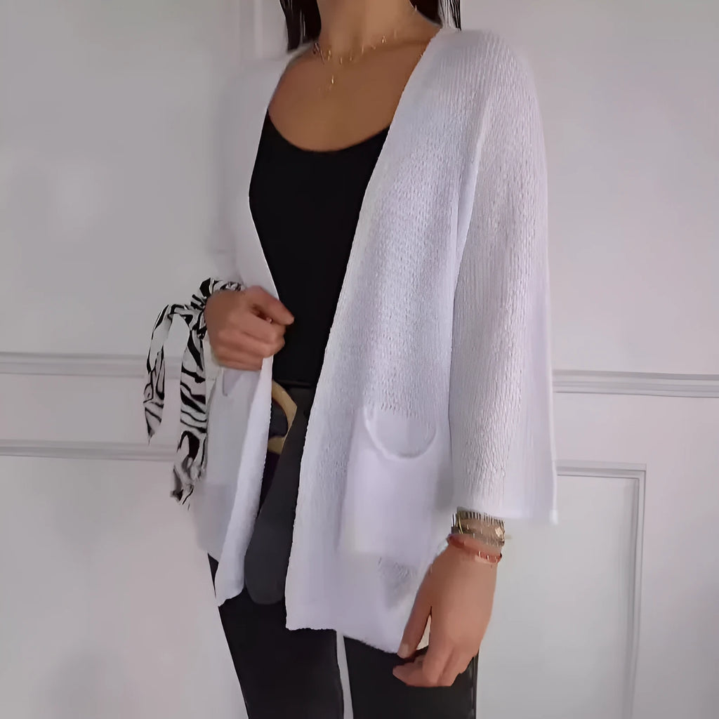 Women's army green waffle texture cardigan coat with nine-quarter sleeves and pockets on a hanger.