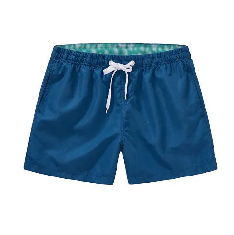 Men's polyester beach shorts in black, shown laid flat, featuring a straight leg opening.