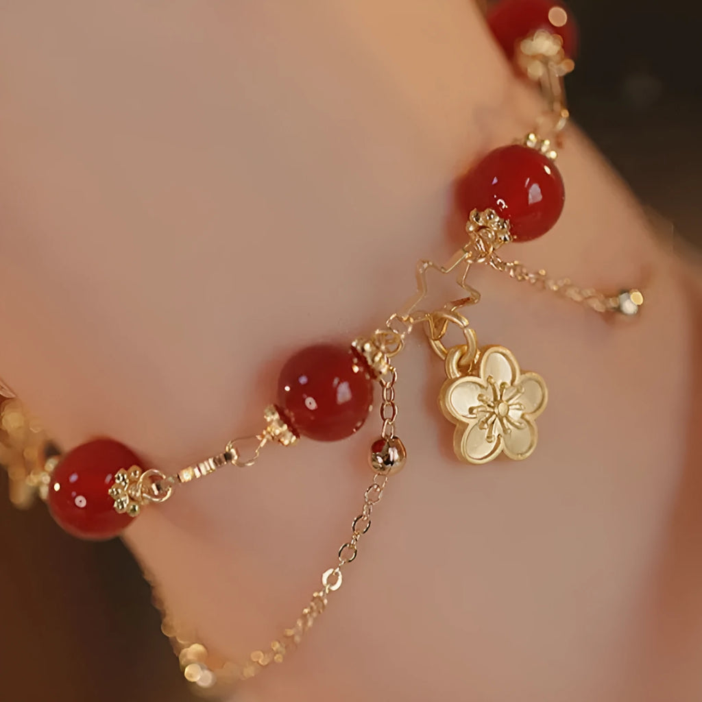 Close-up of natural red agate double layer bracelet with manual floral and peach blossom details for women.