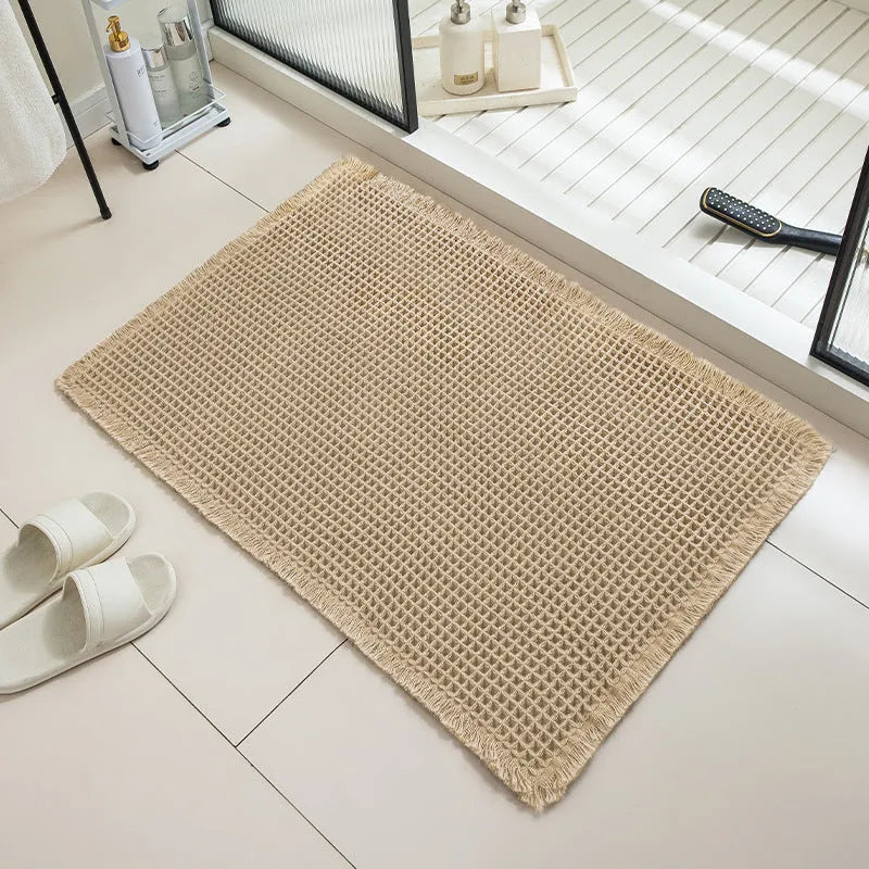 Checkered pattern non-slip absorbent bathroom carpet on a tiled floor.