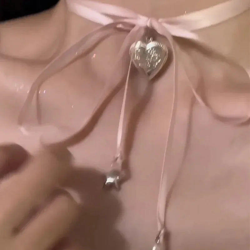 Women's ribbon love pendant fashion necklace on clavicle chain in alloy with electroplated finish
