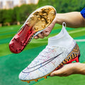 Men's high-top white soccer training shoes with a gold plated sole bottom on artificial grass.