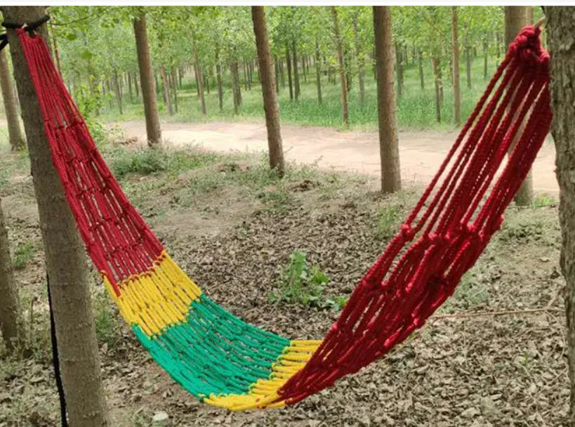 Outdoor nylon rope mesh hammock hung between two trees, showing its 1.1m width and included tying rope.
